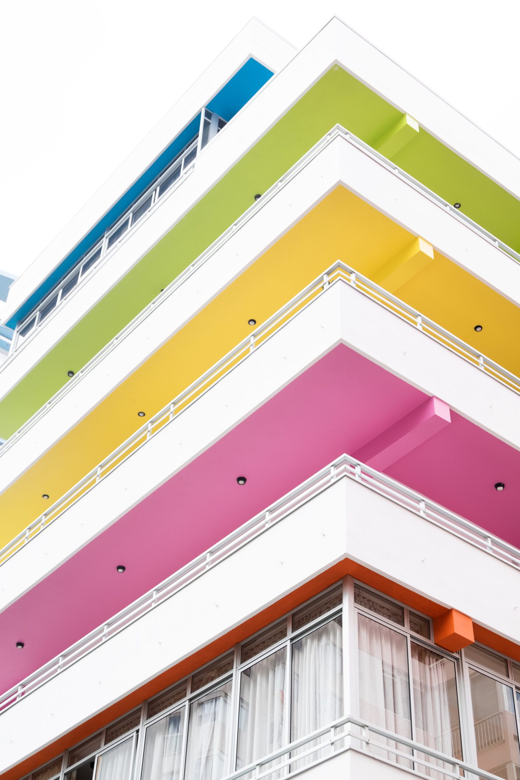 vertical shot building with colorful balconies scaled